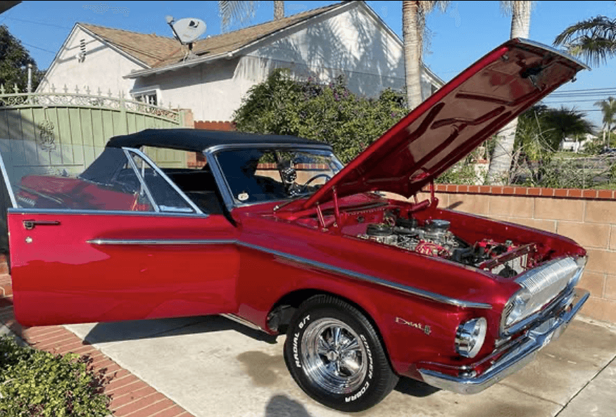 Classic car getting detailed with graffiti background